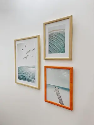 three pictures hanging on a white wall at Apartman DE LUX RADIVOJEVIĆ in Sutomore
