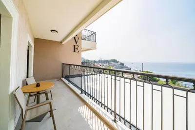 a balcony with a table and a view of the ocean at Exclusive Hotel in Budva