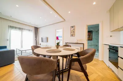 a kitchen and a dining room with a table and chairs at Exclusive Hotel in Budva