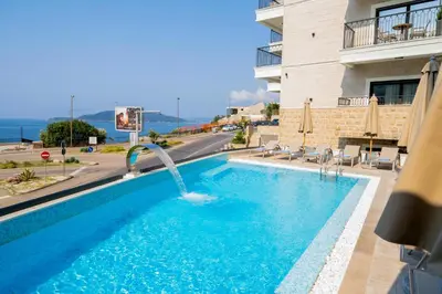 a swimming pool with a water fountain in a building at Exclusive Hotel in Budva