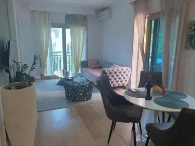a living room with a couch and a table at AVAbys apartman in Pržno