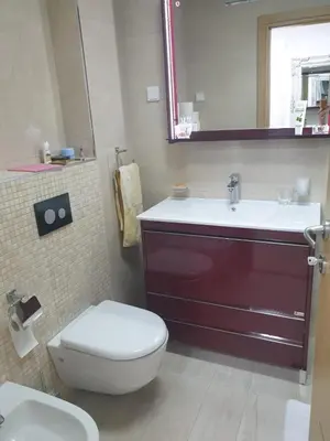 a bathroom with a sink and a toilet and a mirror at AVAbys apartman in Pržno
