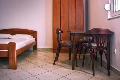 a bedroom with a table and two chairs and a bed at Vera Apartments in Budva