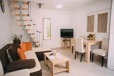 a living room with a couch and a table at Lovely apartment Moki near the center in Kotor