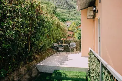 a balcony with a table and chairs on a house at Lovely apartment Moki near the center in Kotor