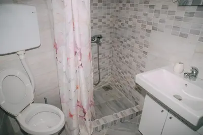 a bathroom with a toilet and a sink at Lovely apartment Moki near the center in Kotor