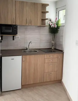 a kitchen with a sink and a refrigerator at Lovely apartment Moki near the center in Kotor