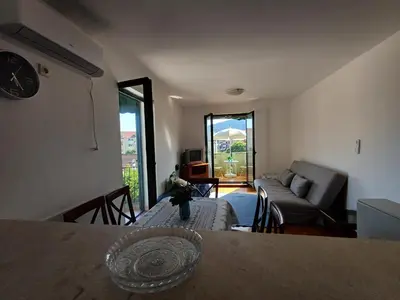 a living room with a table and a couch at Sea breeze Budva in Budva