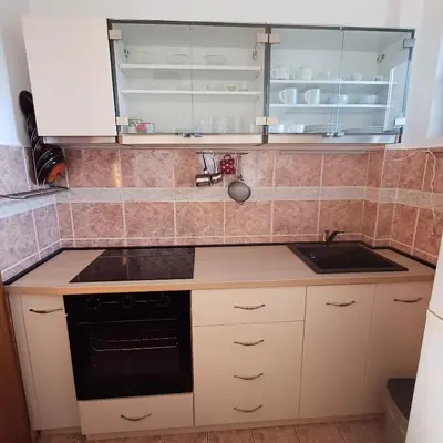 a small kitchen with a sink and a stove at Sea breeze Budva in Budva