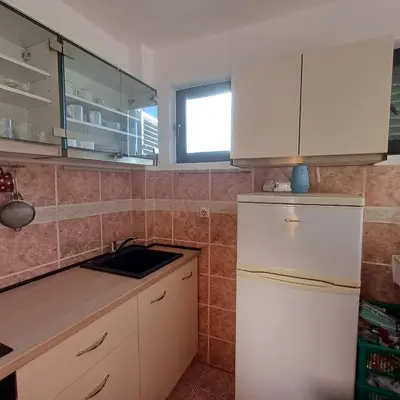 a kitchen with white cabinets and a sink at Sea breeze Budva in Budva