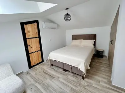 a bedroom with a bed and a wooden floor at Zira in Kotor