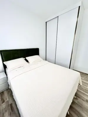 a white bed in a room with a window at Zira in Kotor
