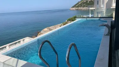 a swimming pool with a view of the ocean at Sea Cliff Villa in Bar