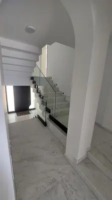 a staircase in a building with a glass railing at Sea Cliff Villa in Bar
