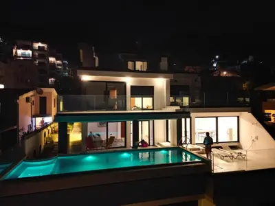 a house with a swimming pool at night at Sea Cliff Villa in Bar