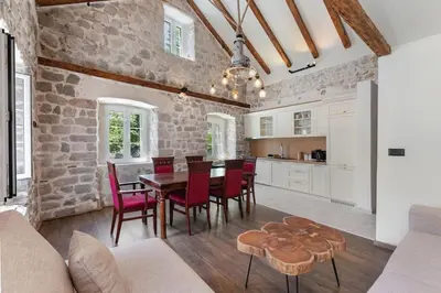 a kitchen and dining room with a table and chairs at Seaside Stone House - Bella Vista in Kotor