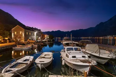 a group of boats docked in a marina at night at Seaside Stone House - Bella Vista in Kotor