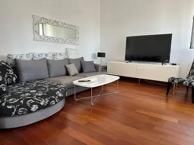 a living room with a couch and a flat screen tv at Sasha's apartment in Bar