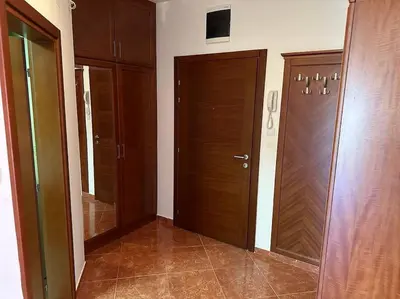 a hallway with two wooden doors in a room at Sasha's apartment in Bar