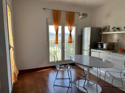 a kitchen with a table and chairs in a kitchen at Sasha's apartment in Bar