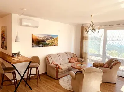 a living room with a couch and a table at Chalet Elli's Mountain View in Velje Selo