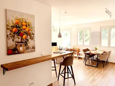 a kitchen and dining room with a painting of oranges at Chalet Elli's Mountain View in Velje Selo