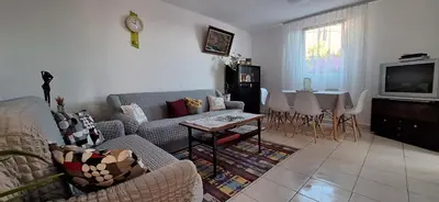 a living room with a couch and a table at Apartment Belis Utjeha in Utjeha
