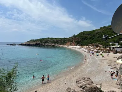 a beach with a group of people in the water at Oliva apartment in Petrovac na Moru