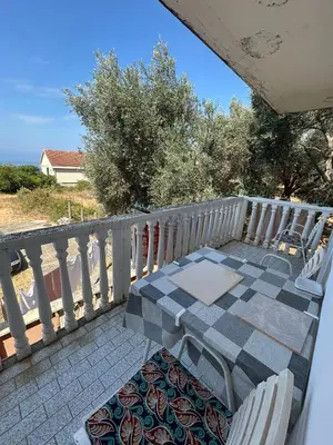 a patio with a table and chairs on a balcony at Oliva apartment in Petrovac na Moru