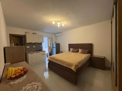 a bedroom with a bed and a bowl of fruit at Kolibri Apartment in Dobra Voda