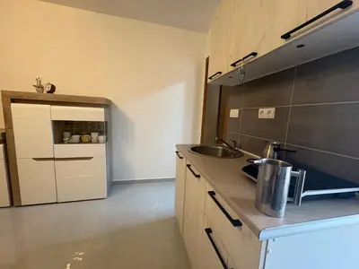 a kitchen with a sink and a counter top at Kolibri Apartment in Dobra Voda