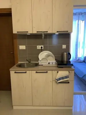 a kitchen with a sink and a counter top at Kolibri Apartment in Dobra Voda