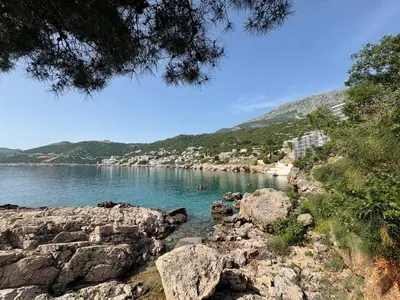 a view of a body of water with rocks at Kolibri Apartment in Dobra Voda