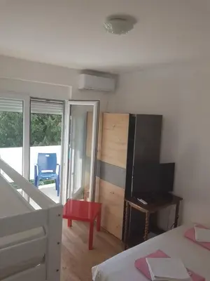 a bedroom with a bed and a flat screen tv at Apartmani Dream 3 in Bar, Susanj