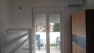 a room with a sliding glass door with a window at Apartmani Dream 3 in Bar, Susanj