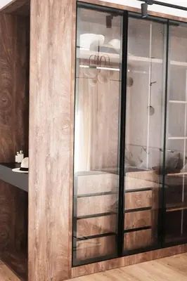 a glass and wooden cabinet in a room at Palastura Apartments in Ulcinj
