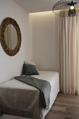 a bedroom with a bed and a mirror on the wall at Palastura Apartments in Ulcinj