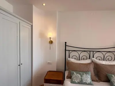 a bedroom with a bed with a lamp and pillows at Palastura Apartments in Ulcinj