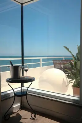 a balcony with a table and a view of the ocean at Palastura Apartments in Ulcinj