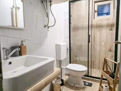 a bathroom with a sink and a toilet and a shower at Hostel Budva in Budva