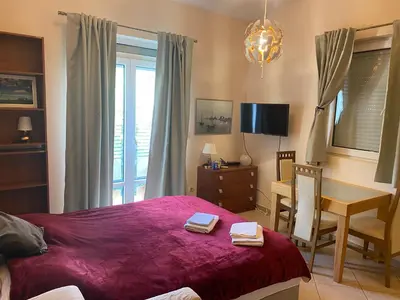 a bedroom with a bed and a desk and a table at Apart Yukka first line in Utjeha