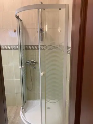 a glass shower in a bathroom with a toilet at Apart Yukka first line in Utjeha