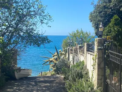 a fence with the ocean in the background at Apart Yukka first line in Utjeha