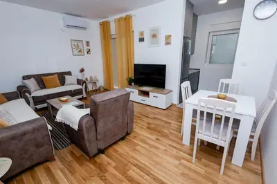 a living room with a couch and a table at Elegant Escape Podgorica in Podgorica