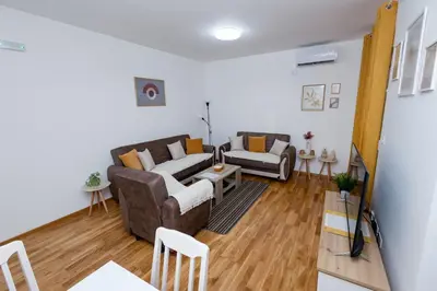 a living room with a couch and a table at Elegant Escape Podgorica in Podgorica