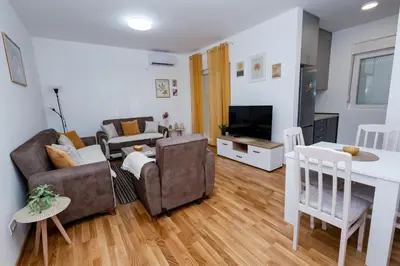 a living room with a couch and a table at Elegant Escape Podgorica in Podgorica