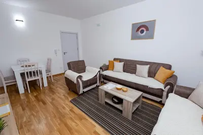 a living room with a couch and a table at Elegant Escape Podgorica in Podgorica