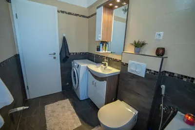 a bathroom with a toilet and a sink at Mantra HOME in Bar
