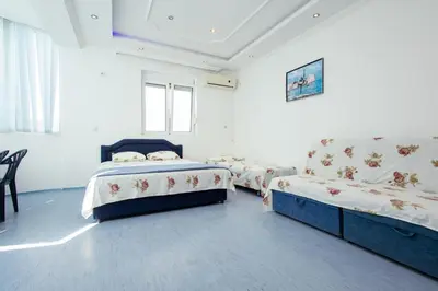 a bedroom with two beds and a couch at Kraja Apartments in Ulcinj