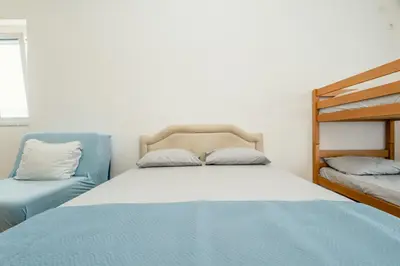 a bedroom with a bed and two bunk beds at Kraja Apartments in Ulcinj